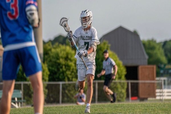 SENIOR CAPTAIN BARRETT Glaser dodged the defender before shooting the ball into the net. The team is led by Glaser's leadership and intense work ethic.