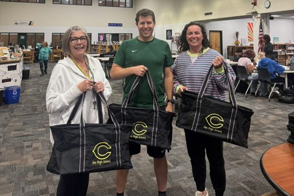MATH TEACHERS ANGIE Noe (left), Sean Duffy, and Melissa Rusak picked up the their Falcon logo gear, along with a boxed lunch from Taste Unlimited. Teachers were gifted items  from various clubs and sports teams throughout the week.